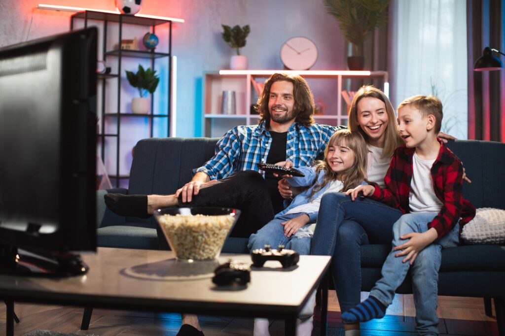 Happy family watching TV at home